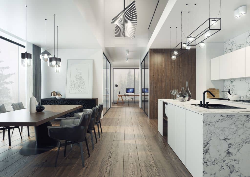 Cocina moderna con encimera de mármol blanco y muebles oscuros, combinando elegancia y funcionalidad. 